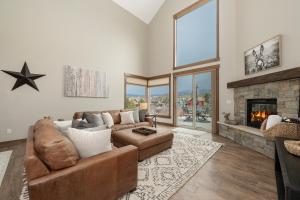 a living room with a couch and a fireplace at 74 Alder Brook in Fraser