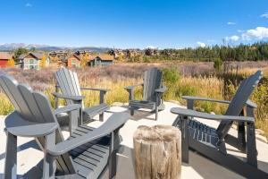 a group of chairs sitting on a deck with a view at 74 Alder Brook in Fraser
