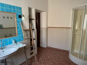 a bathroom with a sink and a shower at La Casetta di Zio Gino in Cingoli +34 photos