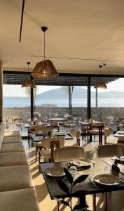 a restaurant with tables and chairs and a view of the desert at Coral Boutique Hotel in Vlorë