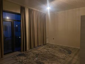 an empty room with a curtain and a window at Billa Sea breeze in Baku