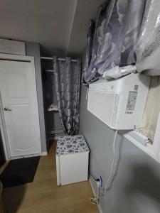 a small kitchen with a microwave and a refrigerator at Queen Private room with private bathroom in Irvington