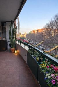 a balcony with flowers and plants on a building at Al Colosseo Quadrato in Rome