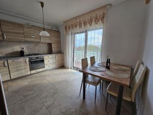 a kitchen with a table and chairs and a window at Dante Residence in Alba Iulia +17 photos