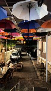 a parking lot with umbrellas and tables and a car at Trakya City Hotel in Edirne