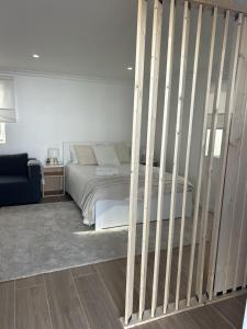 a bedroom with a bed with wooden rails at Modern Studio with Private Patio near Cascais & Sintra in Alcabideche