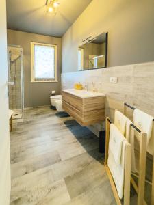 a bathroom with a tub and a sink at B&B Il Grande Cipresso Recanati in Castelnuovo