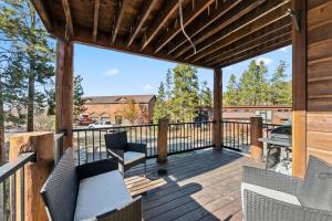a wooden deck with chairs and a table on it at 820 Badger Ln in Fraser