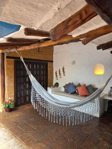 a hanging hammock in a room with a bed at Casa Raisol Barichara in Barichara +63 photos