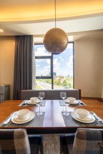 a dining room with a table with plates and wine glasses at A Scenic Escape within Nairobi in Nairobi