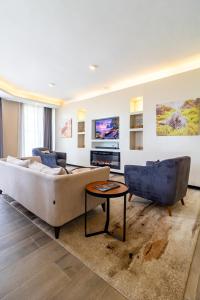 a living room with a couch and a table at A Scenic Escape within Nairobi in Nairobi