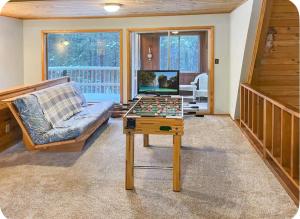 a living room with a table with a chessboard at Elevation Station Surrounded by Wildlife in Angel Fire