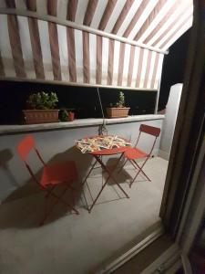 a table and two chairs on a balcony at casamiacasatua in Ronciglione