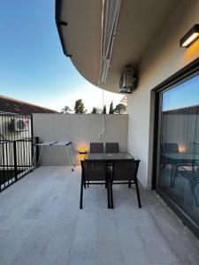 a patio with a ping pong table on a balcony at DEYA Apartment Becici in Boreti