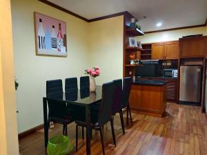 a kitchen with a dining room table and chairs at Patong Tower 2 Bedrooms Sea View Top Top in Patong Beach