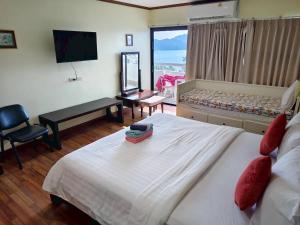 a hotel room with a large bed and a flat screen tv at Patong Tower 2 Bedrooms Sea View Top Top in Patong Beach