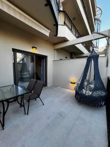 a patio with a hammock on a house at DEYA Apartment Becici in Boreti