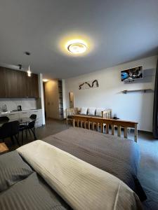 a bedroom with a large bed and a table at DEYA Apartment Becici in Boreti