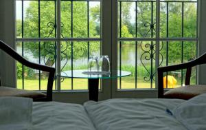 a room with a bed and a table in front of a window at Dorotheenhof in Mescherin