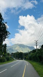 an empty road with a mountain in the distance at Livora Mountain Lodge in Etimole