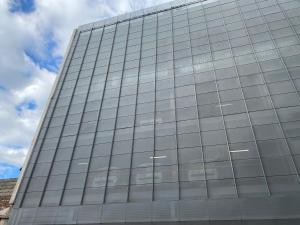 a tall glass building with a sky in the background at La Santiaga Sólo para chicas in Córdoba
