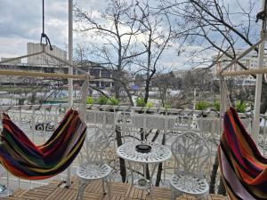 a patio with chairs and a table and a table and chairs at Mery in Craiova