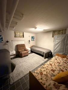 a bedroom with a bed and a couch and a chair at Nordic character in Vidsel