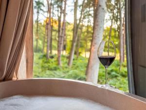 a glass of wine sitting on a window sill at Lady's Slipper-Qu7628 in Chipping Norton