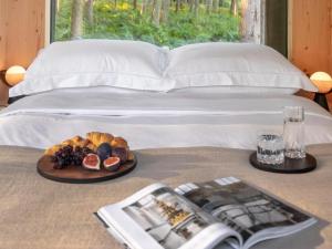 a bed with a tray of food on a table at Lady's Slipper-Qu7628 in Chipping Norton