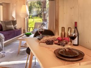 a table with wine bottles and a plate of food at Lady's Slipper-Qu7628 in Chipping Norton