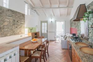 a kitchen with a table and a counter top at Piccola Abbazia by RentAllComo in Lenno