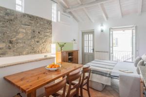 a kitchen and dining room with a wooden table at Piccola Abbazia by RentAllComo in Lenno