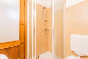 a shower stall in a bathroom with a toilet at Piccola Abbazia by RentAllComo in Lenno