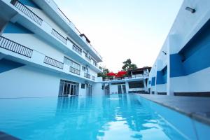 a view of the swimming pool of a building at Hotel Emerald Green in Weligama