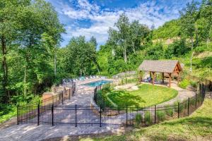 an outdoor swimming pool with a gazebo at Bucky's Bungalow, Free Attraction Tickets, Hot Tub, WIFI!!! in Gatlinburg