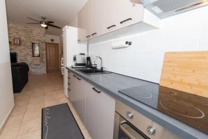 a kitchen with a sink and a counter top at Laurentina - Modern Apartment with Large Terrace near Beach-quiet and comfortable in Sutivan
