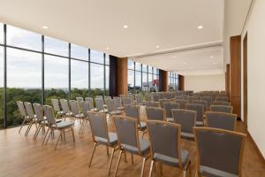a room with chairs and tables and windows at Four Points by Sheraton Pontianak in Pontianak +70 photos
