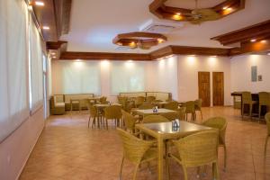 a restaurant with tables and chairs in a room at Honduras Shores Plantations in Tela