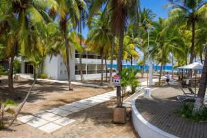 a resort on the beach with palm trees at Honduras Shores Plantations in Tela