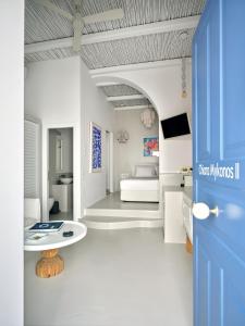 a room with a blue door and a room with a bed at Chiara Mykonos in Mikonos +31 photos