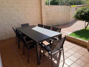 a black table and chairs on a patio at Apartamento Río Bispo in Bueu