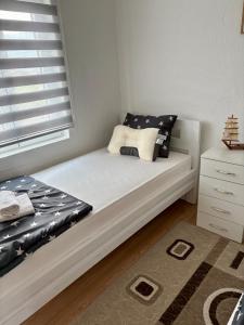 a small bedroom with a bed and a window at Philippos in Bujanovac
