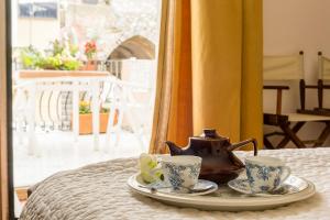 a tea pot and two cups on a table at SUITE MARINELLA -TAORMINA in Taormina