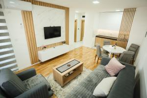a living room with a couch and a table at BK Apartman in Zlatibor