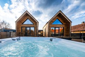 ein Haus mit einem großen Whirlpool im Garten in der Unterkunft Ypsilon - Pixel in Târgu Secuiesc