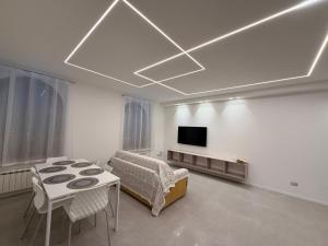a living room with a couch and a table and a tv at Da Nella 2 in Ancona