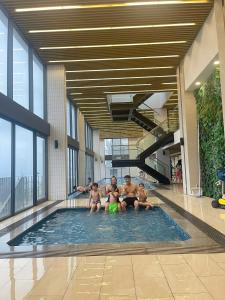 a group of people sitting in a swimming pool at Homestay THAIPHONG DRAGON CASTLE Bãi Cháy in Ha Long