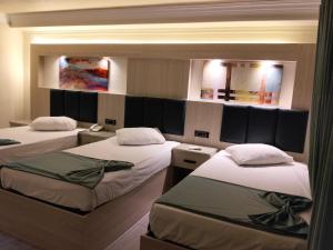 a room with three beds and two mirrors at Havana Hotel Cairo in Cairo +52 photos