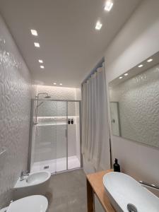 a white bathroom with two sinks and a shower at Da Nella 2 in Ancona +37 photos