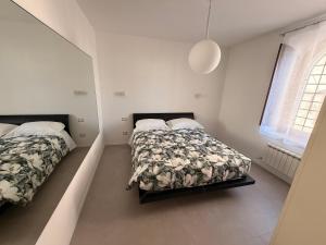 a bedroom with two beds and a window at Da Nella 2 in Ancona
